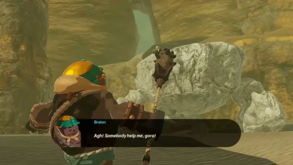 Braton stands beside a boulder with his club Braton stands beside a boulder with his club