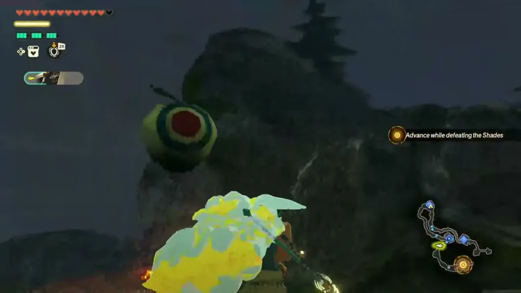 A Korok balloon bobs beside a rock cliff as Rauru closes in