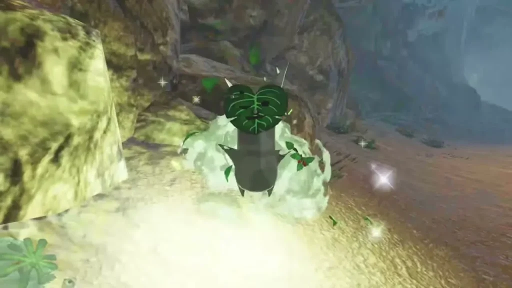 A Korok with a leaf face pops out of the glowing ground in a rocky cave