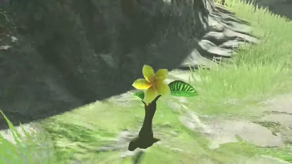 A yellow Korok flower with a green leaf grows on the stone path