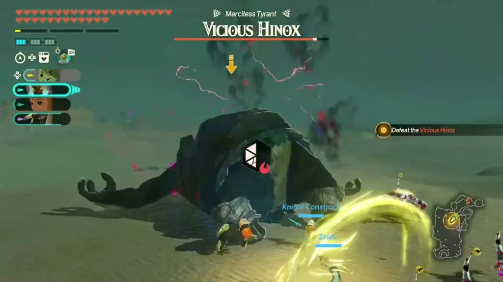 The Vicious Hinox lies stunned on the sand while the party strikes