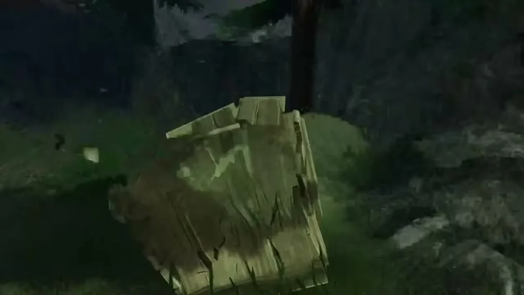 A wooden crate beside a tree breaks apart in the grass