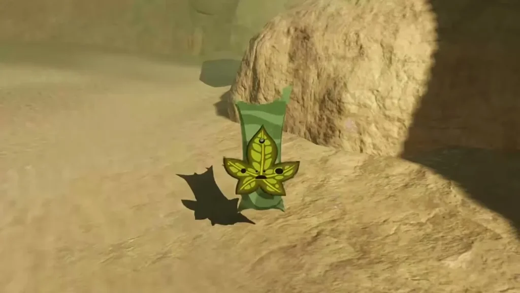 A Korok with a yellow leaf mask stands beside the rocks A Korok with a yellow leaf mask stands beside the rocks