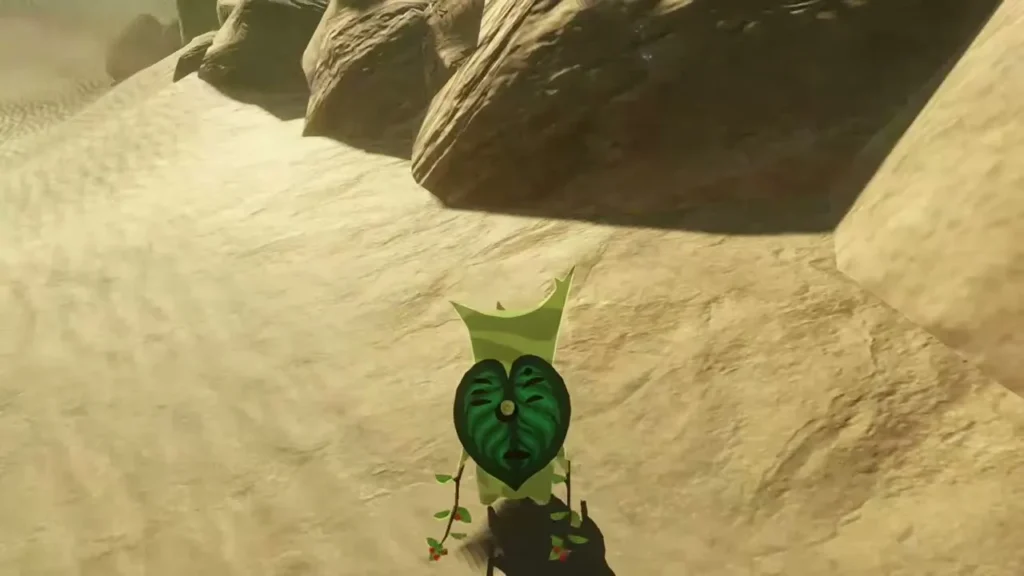 A Korok with a green leaf face appears in the sand A Korok with a green leaf face appears in the sand