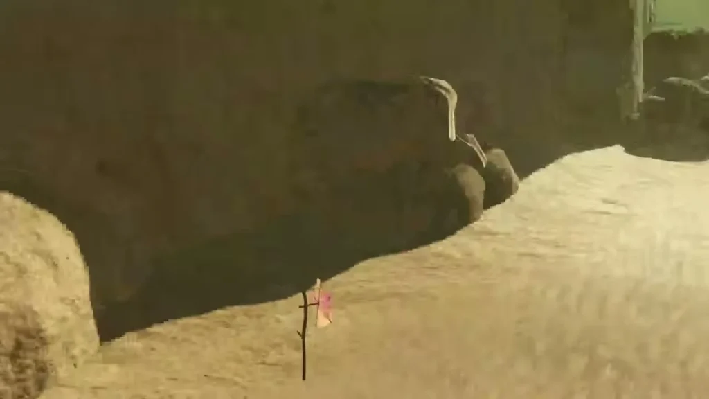 A pink pinwheel on a stick stands in a gap between desert rocks A pink pinwheel on a stick stands in a gap between desert rocks