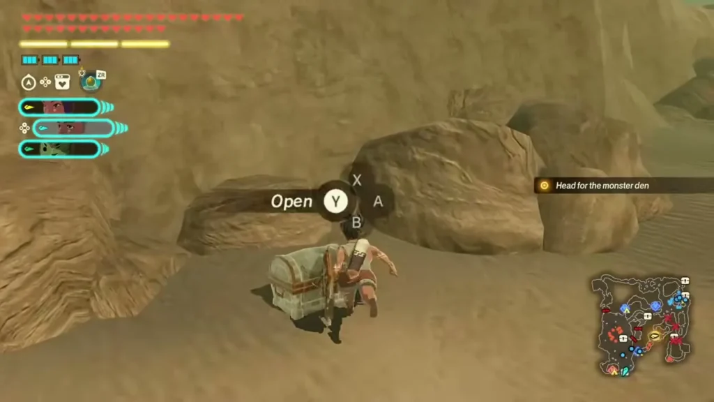 A chest sits beside a boulder on the sand with an Open prompt A chest sits beside a boulder on the sand with an Open prompt