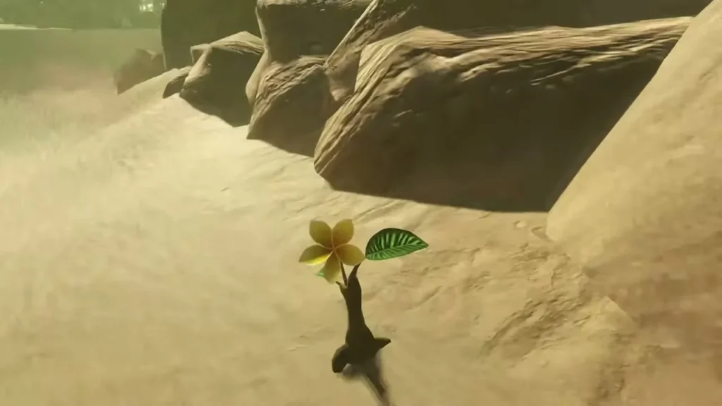 A yellow Korok flower grows beside rocks on the sand path A yellow Korok flower grows beside rocks on the sand path