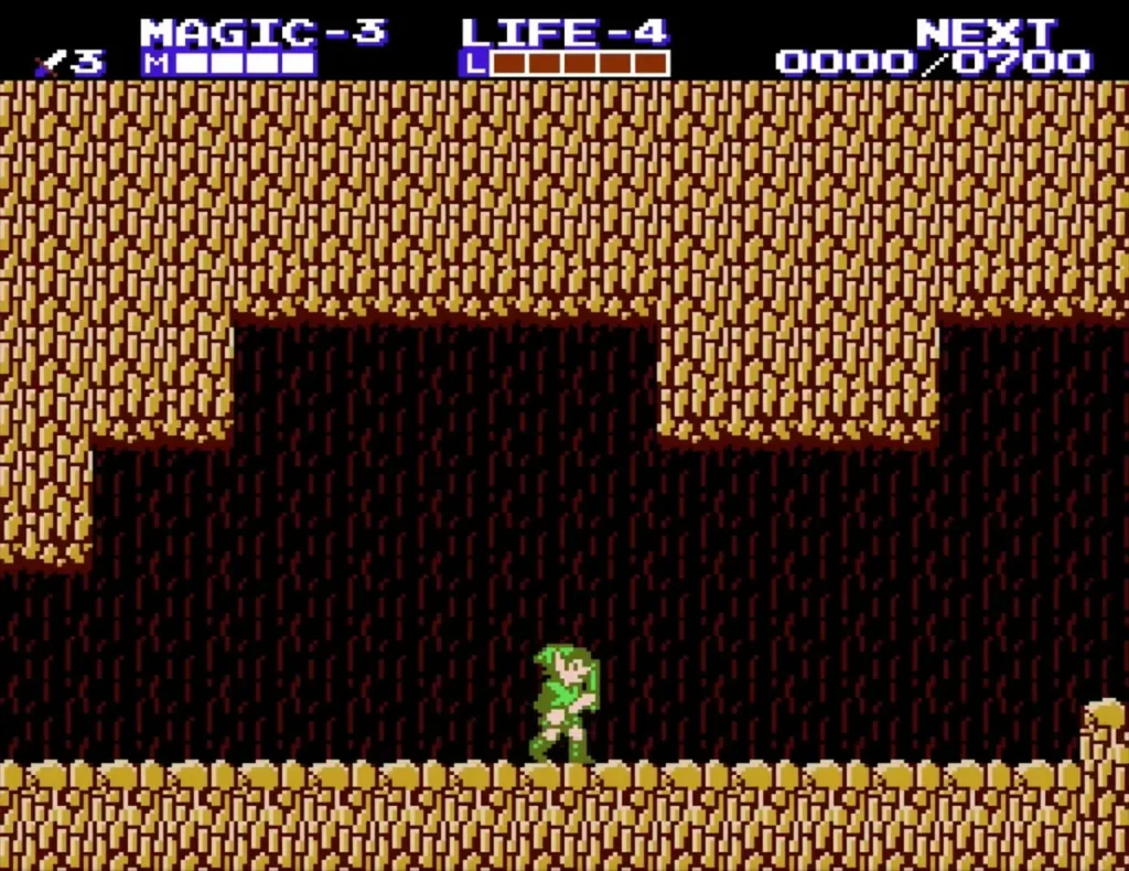 Link on a ledge in a brown rock cave, seen from the side Link on a ledge in a brown rock cave, seen from the side