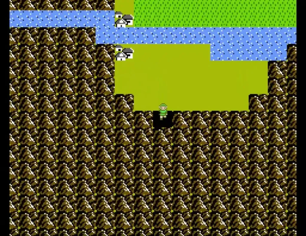Overhead view of Link on brown rocky ground beside a river and grass