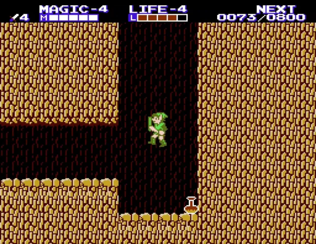 Link at the bottom of a narrow brown rock shaft with a flask on the floor beside him