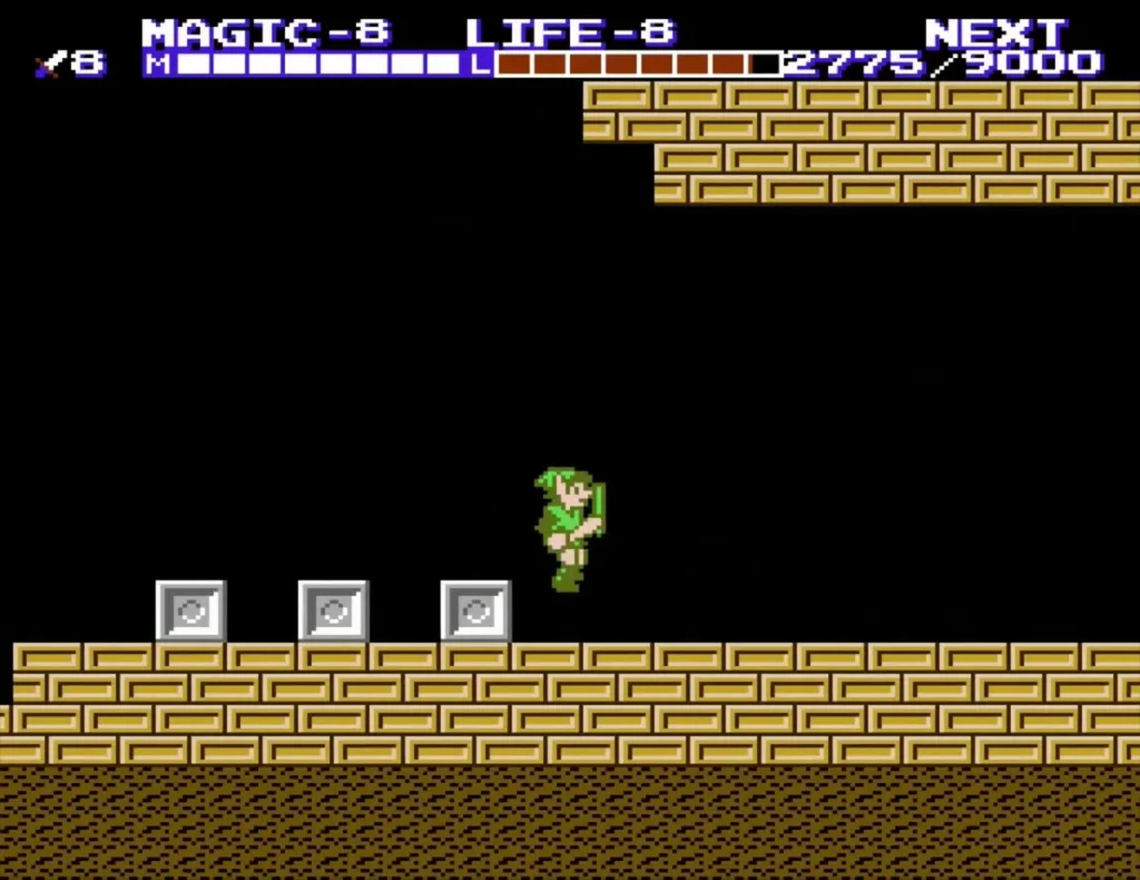 Link on the tan-brick ledge above three grey blocks near the palace