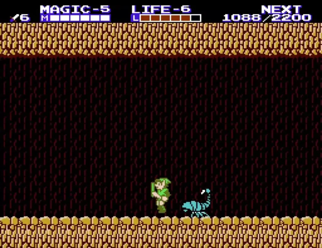 Link in the dark cave fighting a cyan scorpion on the floor
