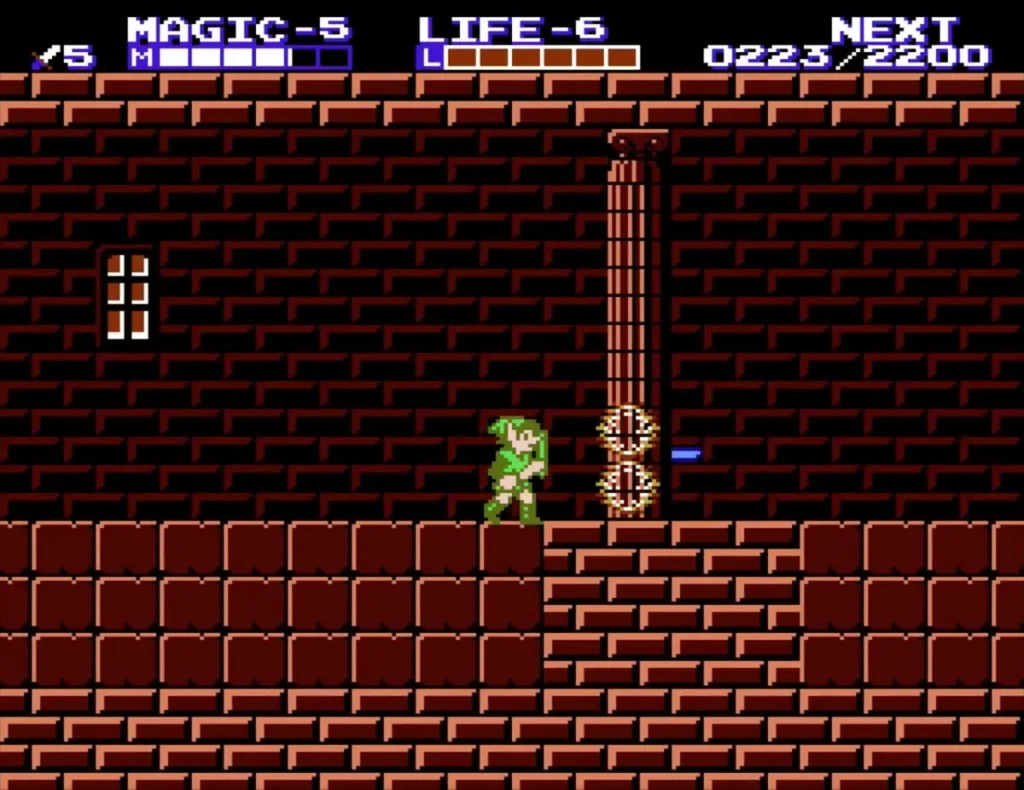 Link beside a column in a dark red brick room with a flame on the floor