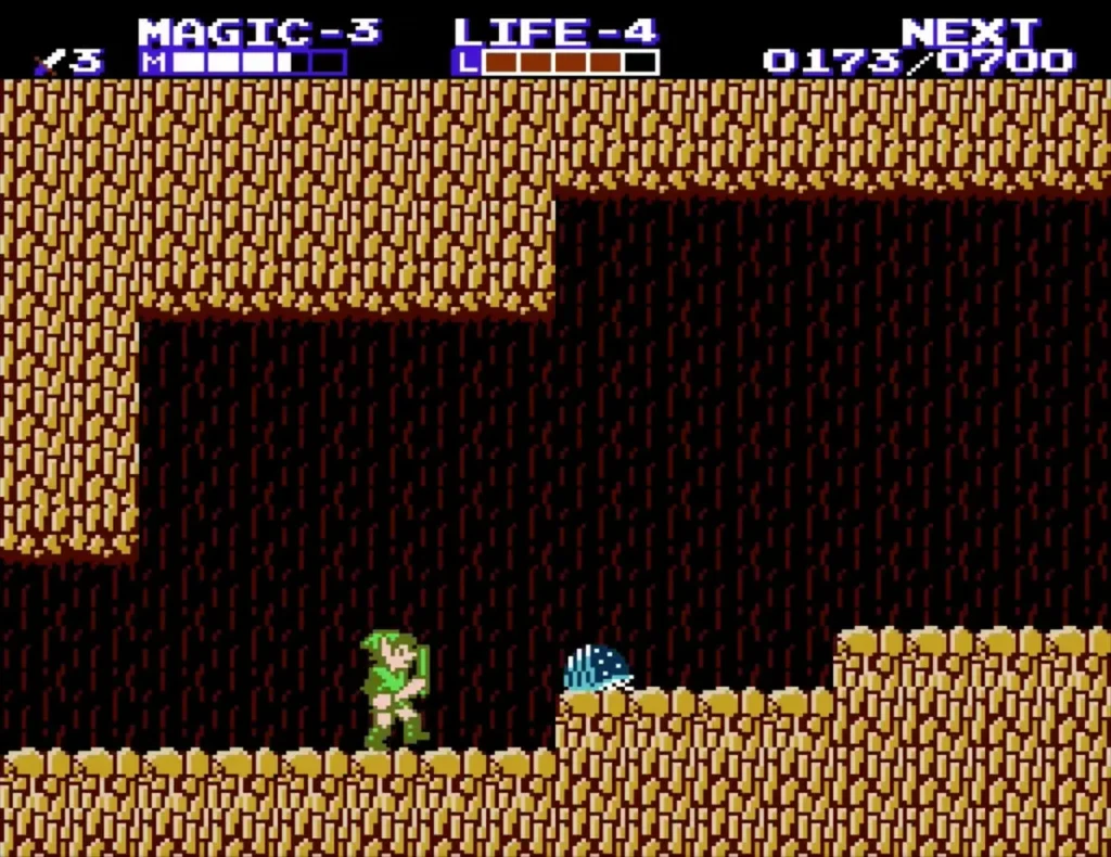 Link next to a blue spiky enemy on the cave floor Link next to a blue spiky enemy on the cave floor