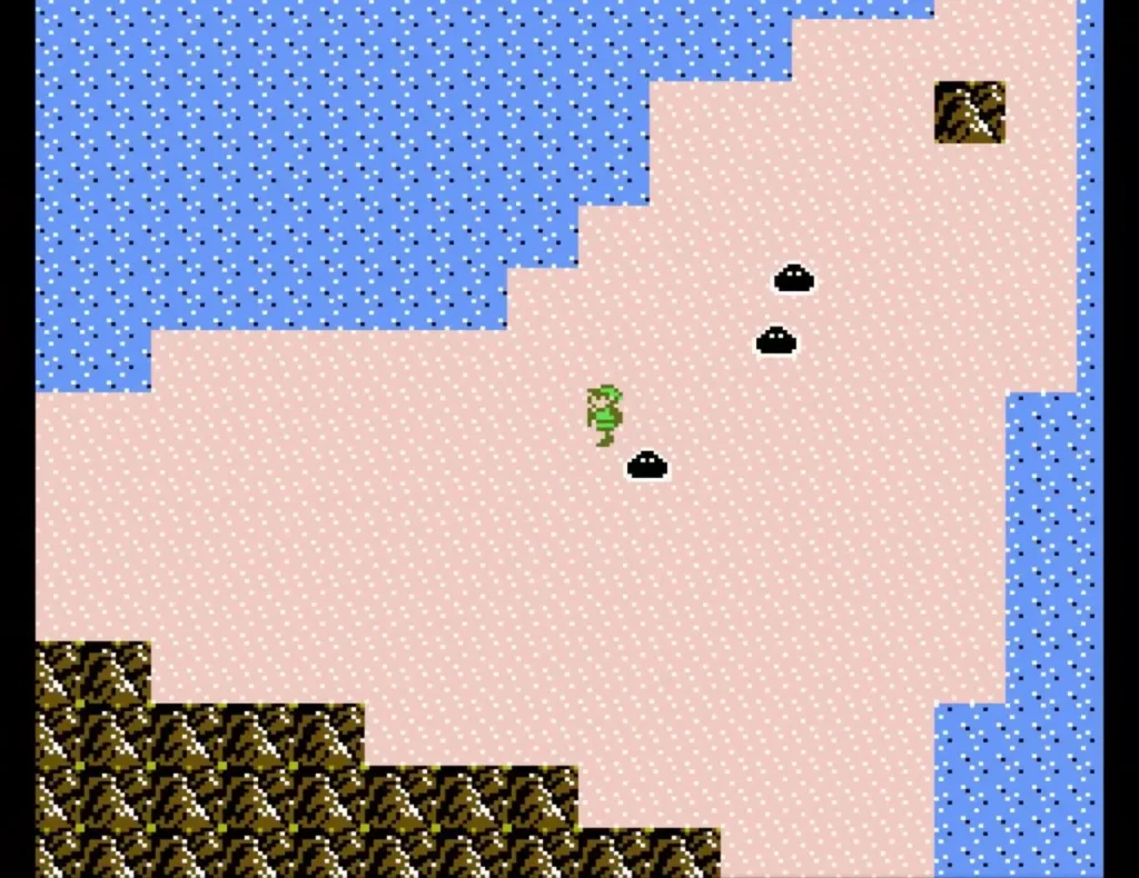 Link crossing pink desert sand past black blob enemies Link crossing pink desert sand past black blob enemies