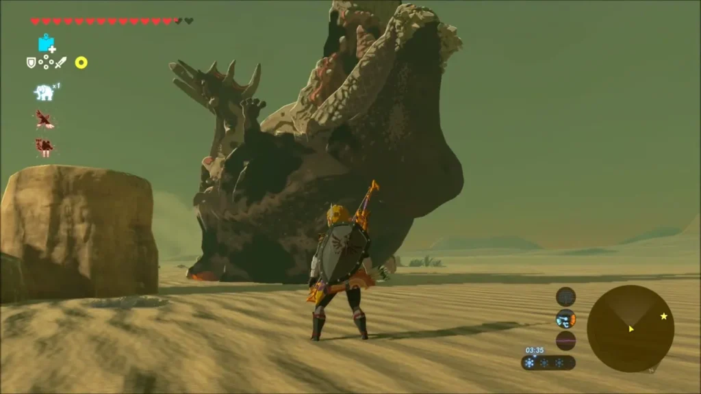 Molduga slumped on the sand at low health as Link stands ready Molduga slumped on the sand at low health as Link stands ready