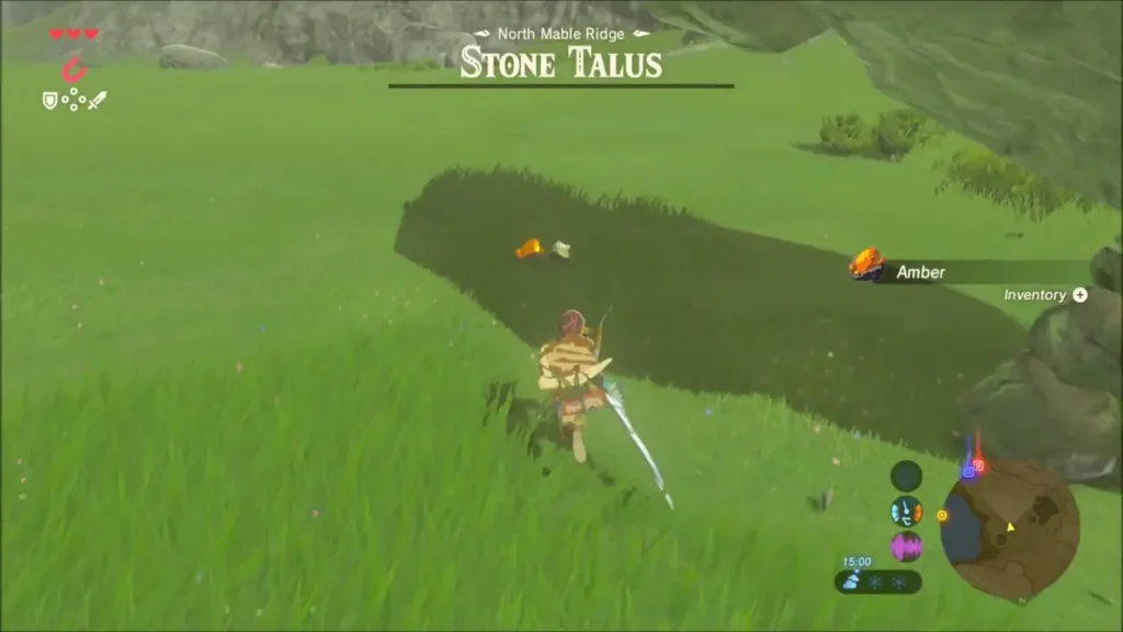Link running to pick up a glowing Amber dropped by the defeated Stone Talus Link running to pick up a glowing Amber dropped by the defeated Stone Talus
