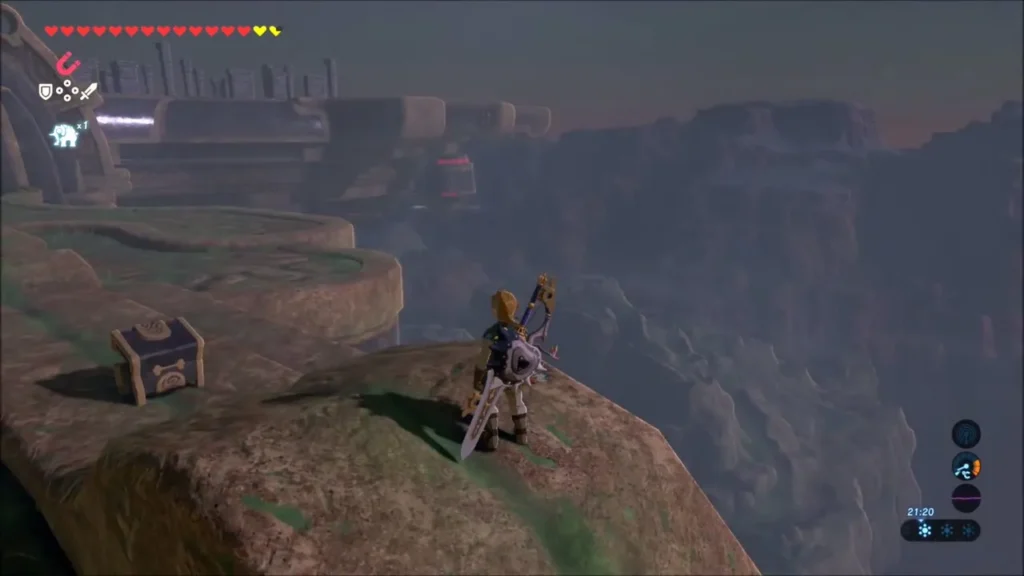 Link on a rocky ledge outside Vah Medoh beside a closed treasure chest Link on a rocky ledge outside Vah Medoh beside a closed treasure chest