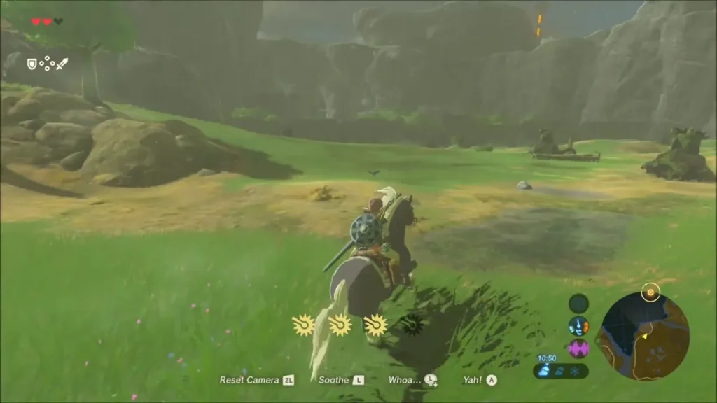 Link riding across the grassy field toward Fort Hateno Link riding across the grassy field toward Fort Hateno
