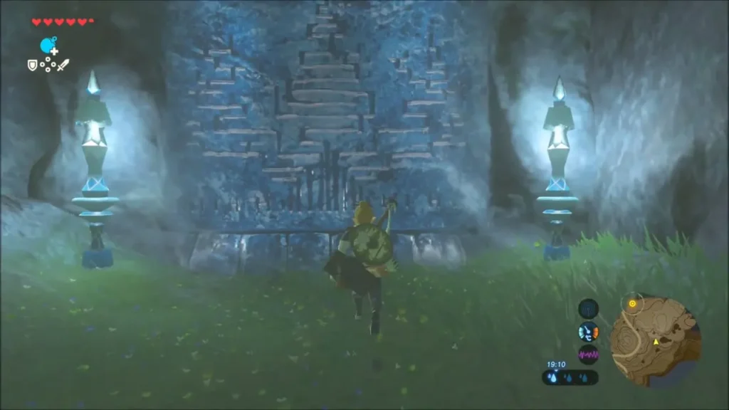Link running toward a carved blue Zora history wall between two lanterns Link running toward a carved blue Zora history wall between two lanterns