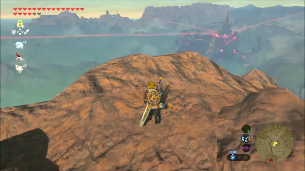 Link on a rocky ridge with Hyrule Castle and the Calamity beams in the distance Link on a rocky ridge with Hyrule Castle and the Calamity beams in the distance
