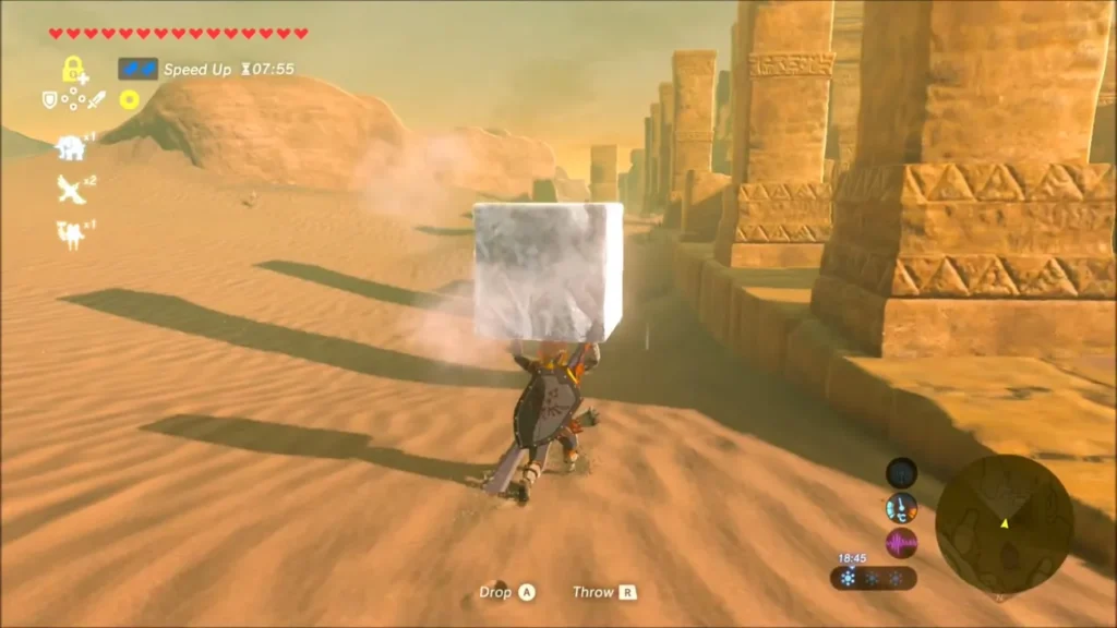 Link carrying the ice block across the sand beside ruined pillars Link carrying the ice block across the sand beside ruined pillars