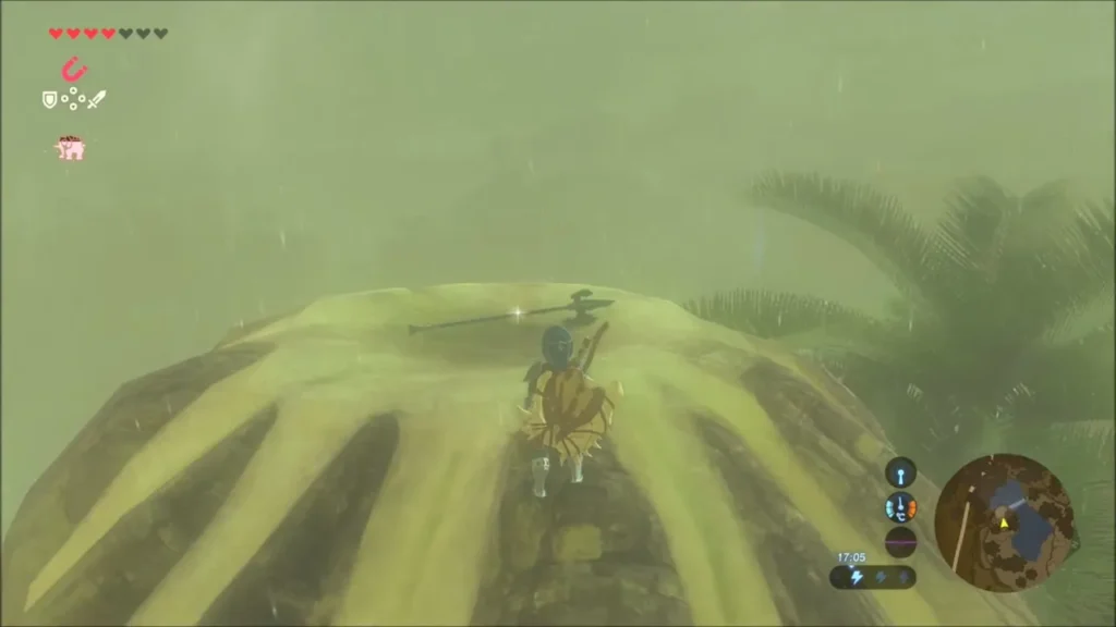 A metal halberd lying on top of the rock mound with Link beside it