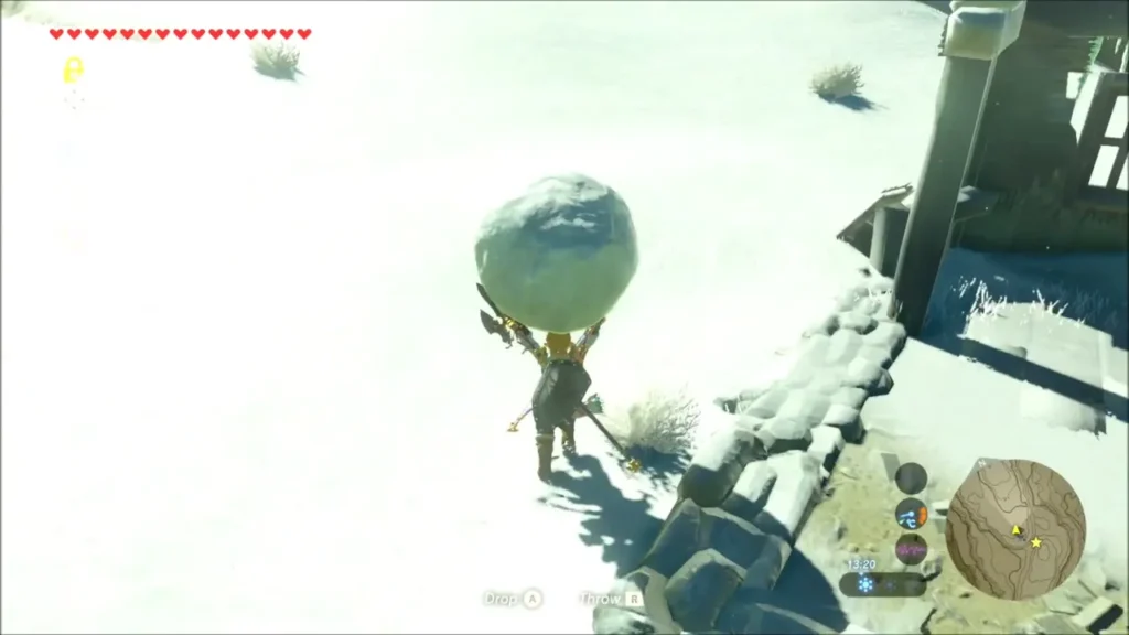 Link carrying a large snowball across the snowy slope Link carrying a large snowball across the snowy slope