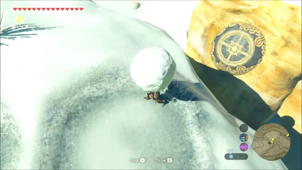 Link holding a snowball beside the golden rock with the circular pedestal Link holding a snowball beside the golden rock with the circular pedestal