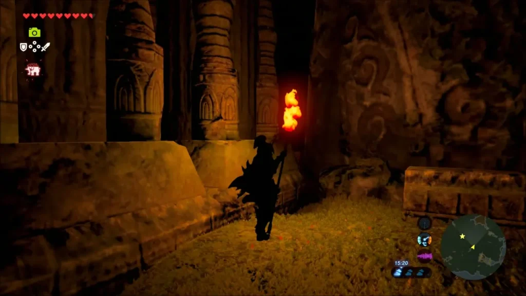 Link holding a torch beside carved stone pillars Link holding a torch beside carved stone pillars