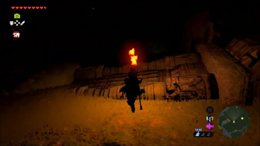 Link with a torch passing carved stone ruins Link with a torch passing carved stone ruins