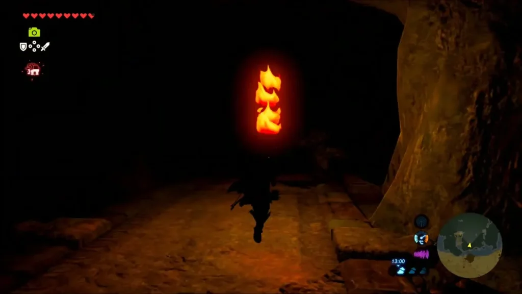 Link carrying a lit torch through the dark cave entrance Link carrying a lit torch through the dark cave entrance