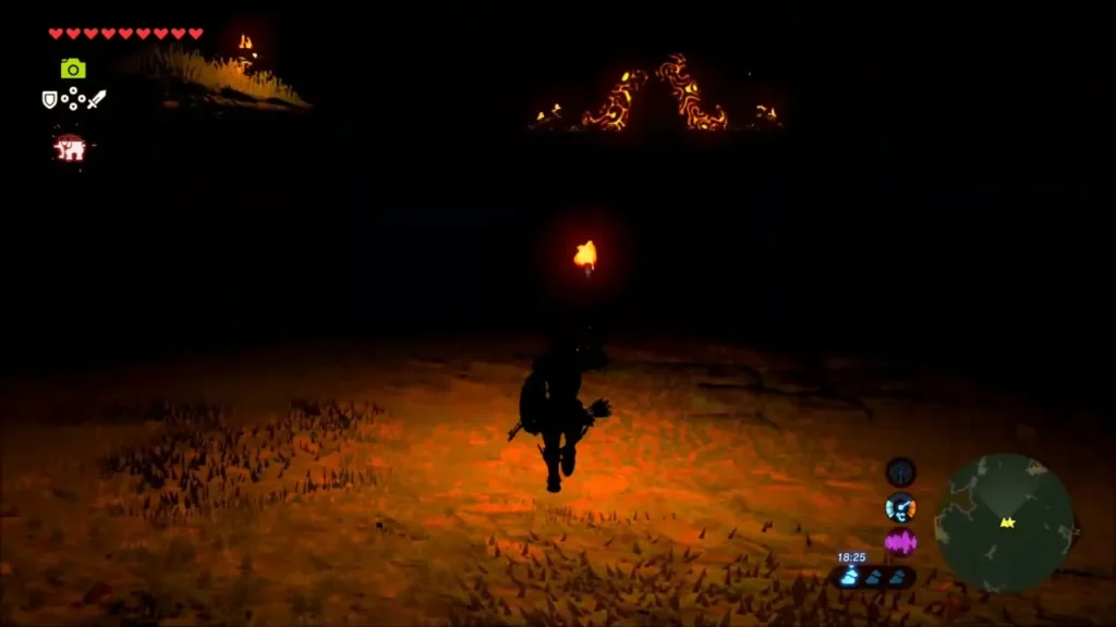 Link carrying a torch across dark ground toward the glowing ruins Link carrying a torch across dark ground toward the glowing ruins