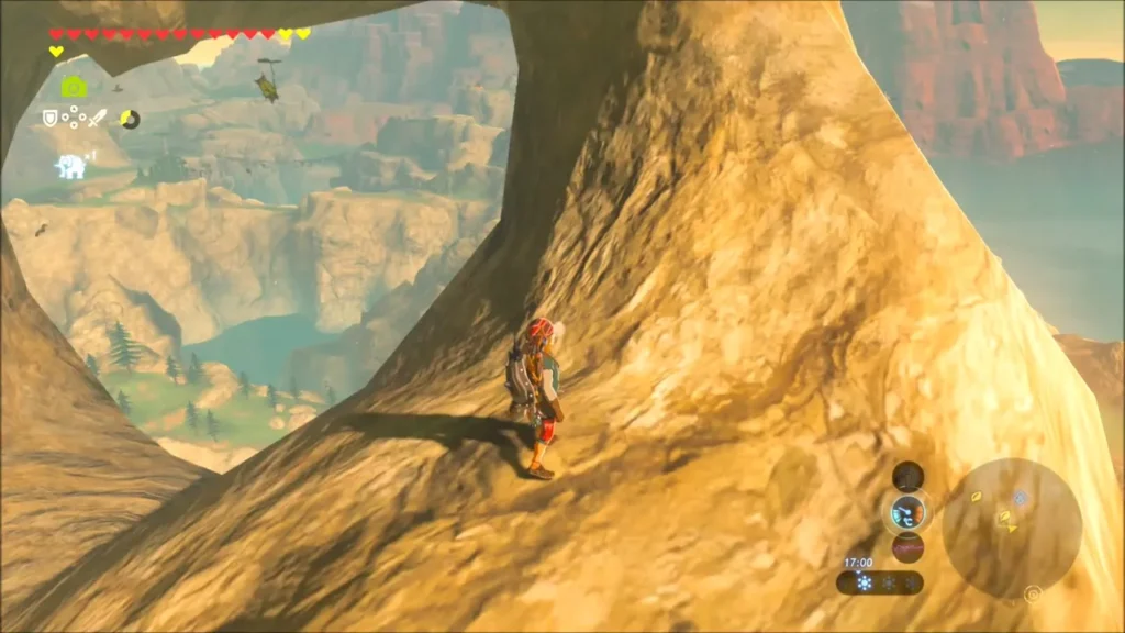 Link climbing the face of a rock arch high above the valley Link climbing the face of a rock arch high above the valley