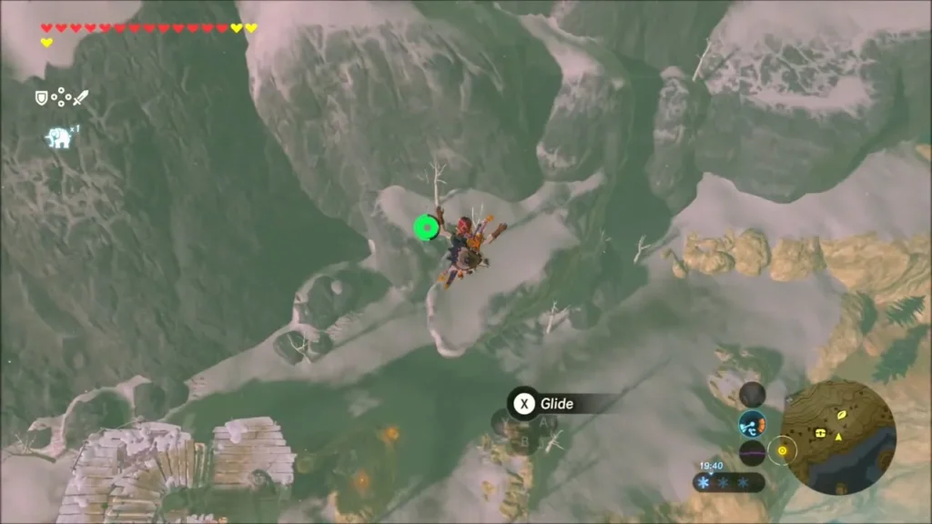 Link gliding down toward a snow-covered cliff shelf Link gliding down toward a snow-covered cliff shelf