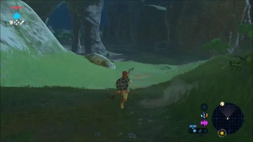 Link running along a grassy canyon path toward the statue area Link running along a grassy canyon path toward the statue area