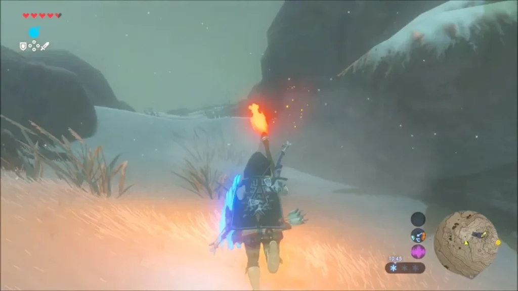 Link running through the snow on Mount Lanayru with a lit torch Link running through the snow on Mount Lanayru with a lit torch