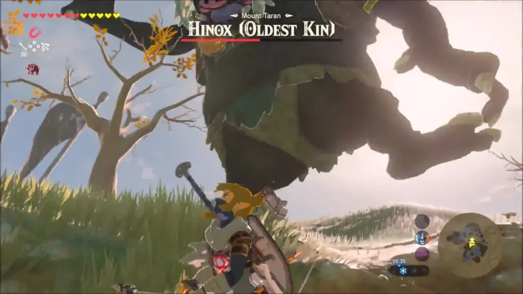 Link fighting the huge Hinox beneath its stomping feet Link fighting the huge Hinox beneath its stomping feet