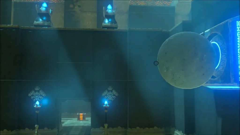 Stone ball hanging beside a wall plunger, with a chest visible beyond the gate Stone ball hanging beside a wall plunger, with a chest visible beyond the gate