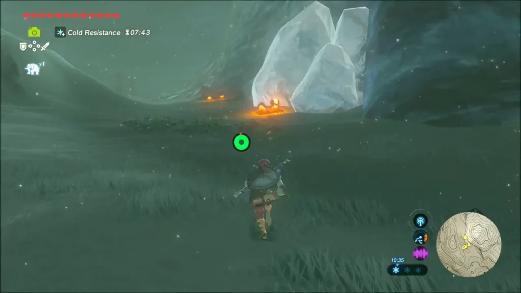 Ice blocks melting over a fire at the foot of the cliff Ice blocks melting over a fire at the foot of the cliff