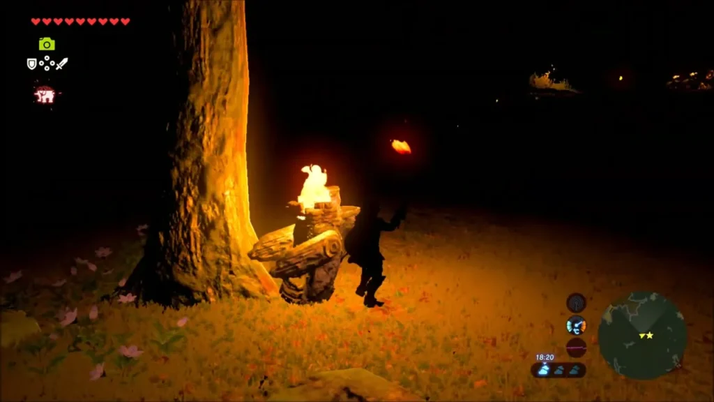 Link holding a torch beside a bird-shaped statue burning at the base of a tree Link holding a torch beside a bird-shaped statue burning at the base of a tree