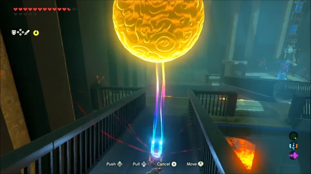 Link pulling a large metal boulder with Magnesis on a railed walkway in Mo'a Keet Shrine Link pulling a large metal boulder with Magnesis on a railed walkway in Mo'a Keet Shrine