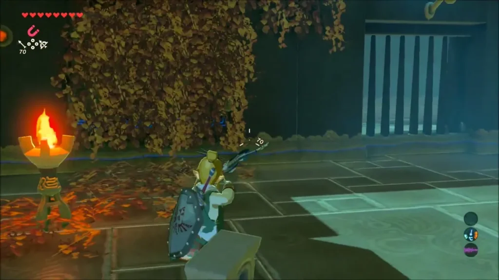 Link aiming a bow at a thick patch of dry leaves near a grated doorway Link aiming a bow at a thick patch of dry leaves near a grated doorway