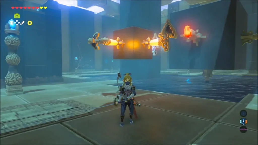Link facing the block with torch stands lit on both sides above the water