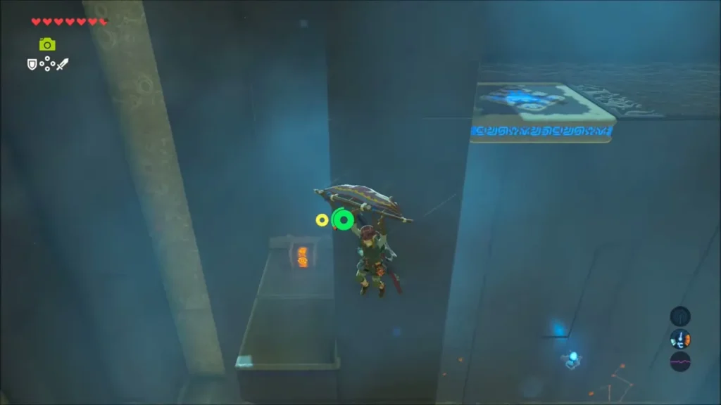 Link paragliding toward a ledge holding a chest in Shee Venath Shrine Link paragliding toward a ledge holding a chest in Shee Venath Shrine