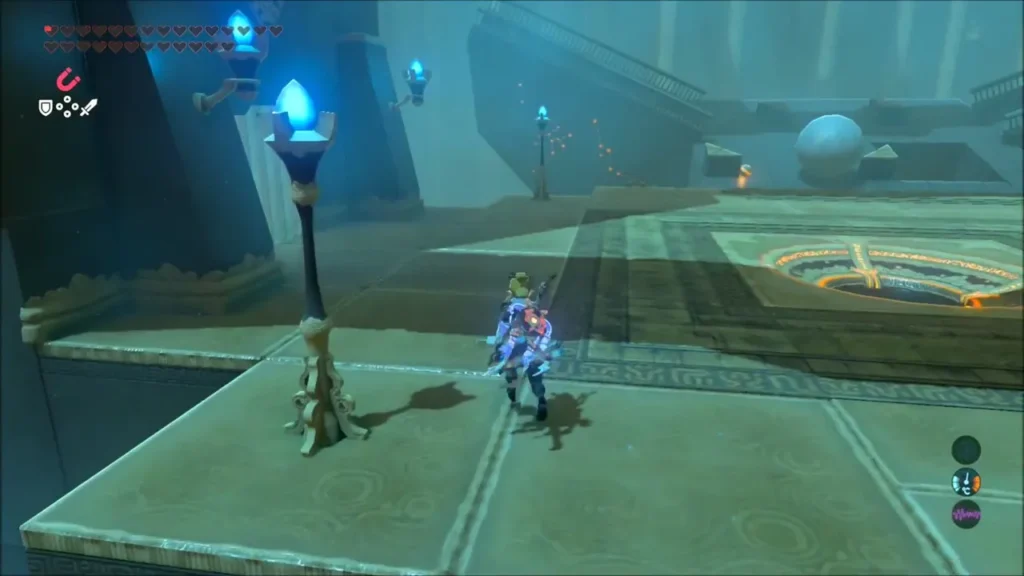 Link walking along a stone ledge beside a large ball and a lit torch Link walking along a stone ledge beside a large ball and a lit torch