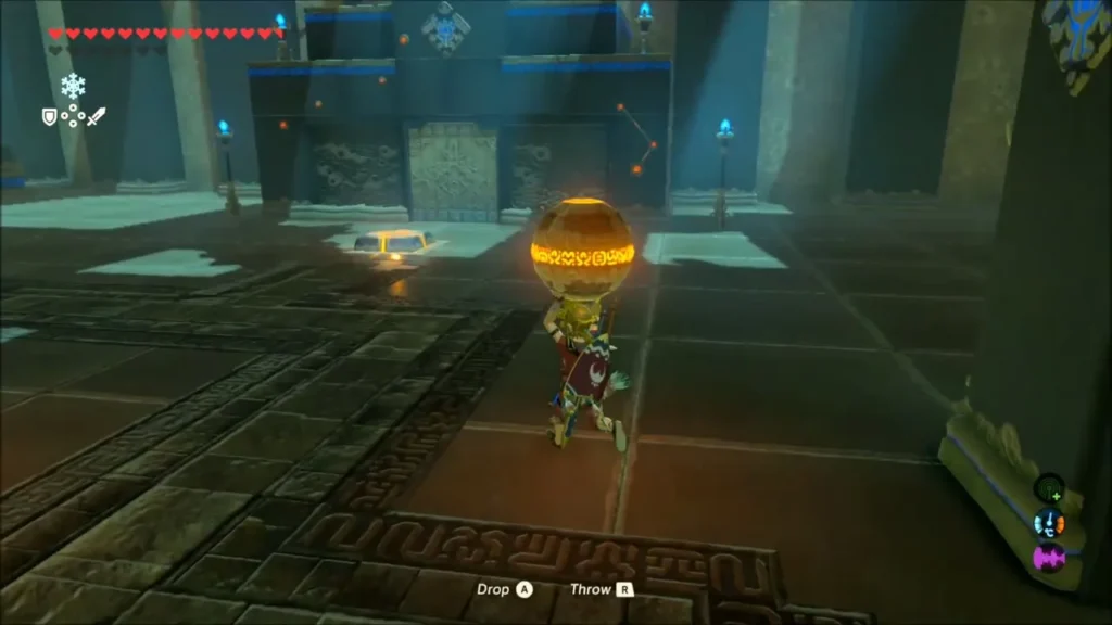 Link carrying the glowing second orb across the shrine floor Link carrying the glowing second orb across the shrine floor