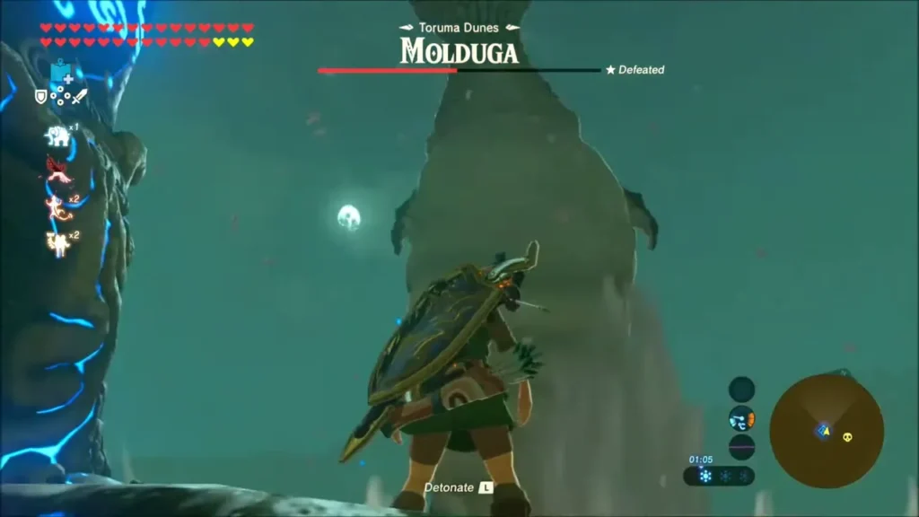A Molduga rising from the sand as Link prepares to detonate A Molduga rising from the sand as Link prepares to detonate