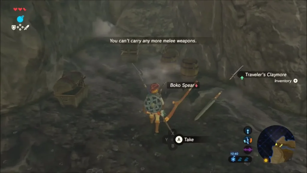 Link picking up a weapon from the cave floor beside a chest Link picking up a weapon from the cave floor beside a chest