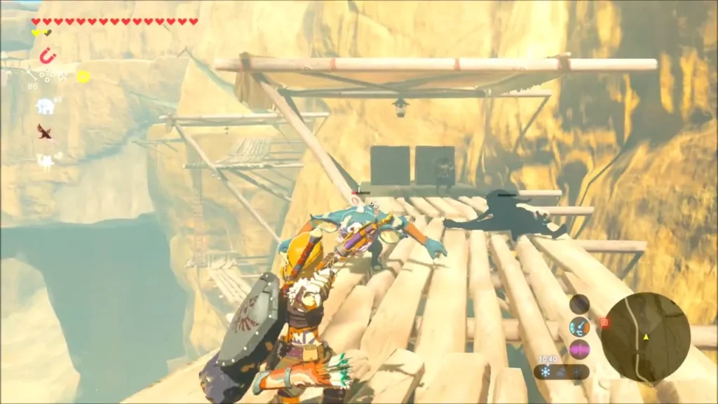 Link attacking a Bokoblin on a scaffold walkway in the canyon cliffs Link attacking a Bokoblin on a scaffold walkway in the canyon cliffs